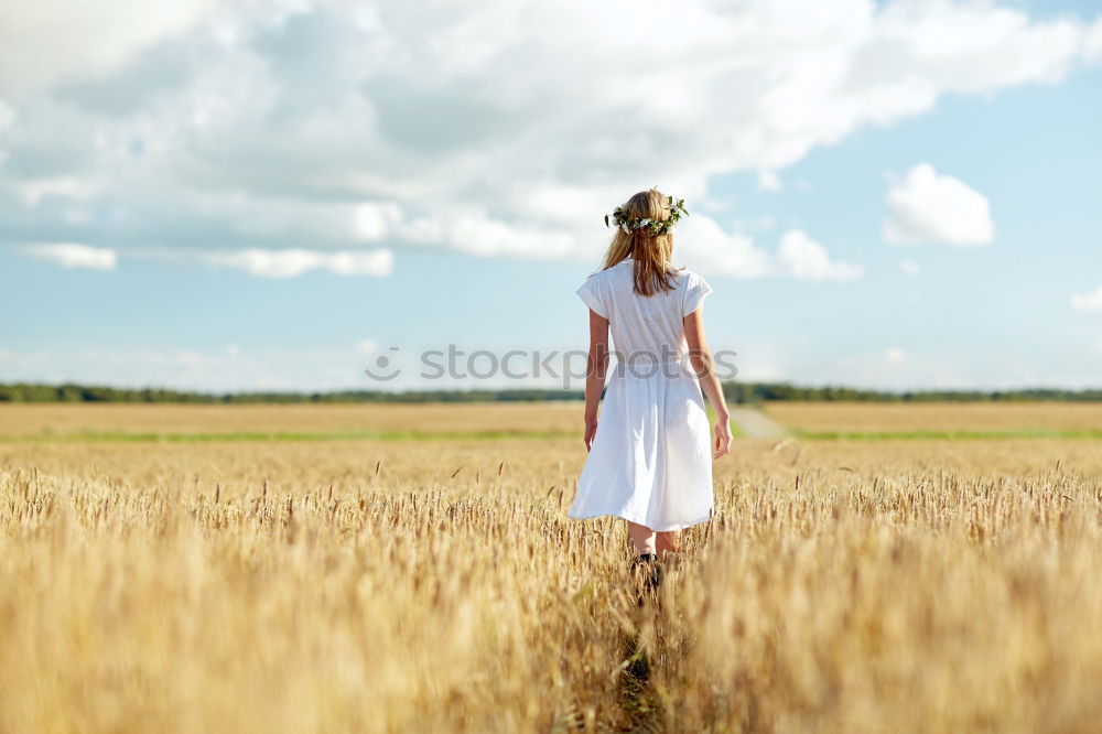 Similar – Boy with hat goes over mowed field