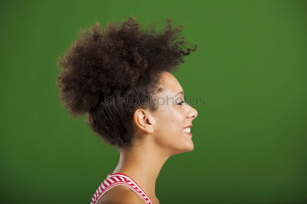 Similar – Black woman with afro hairstyle smiling in urban park.