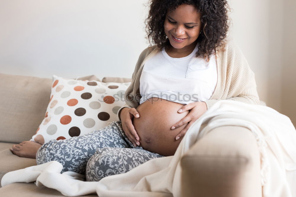 Similar – Pregnant woman touching her belly