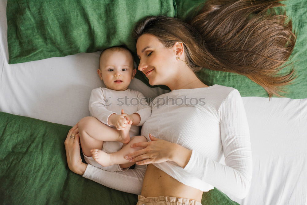 Baby girl playing with mother and have fun