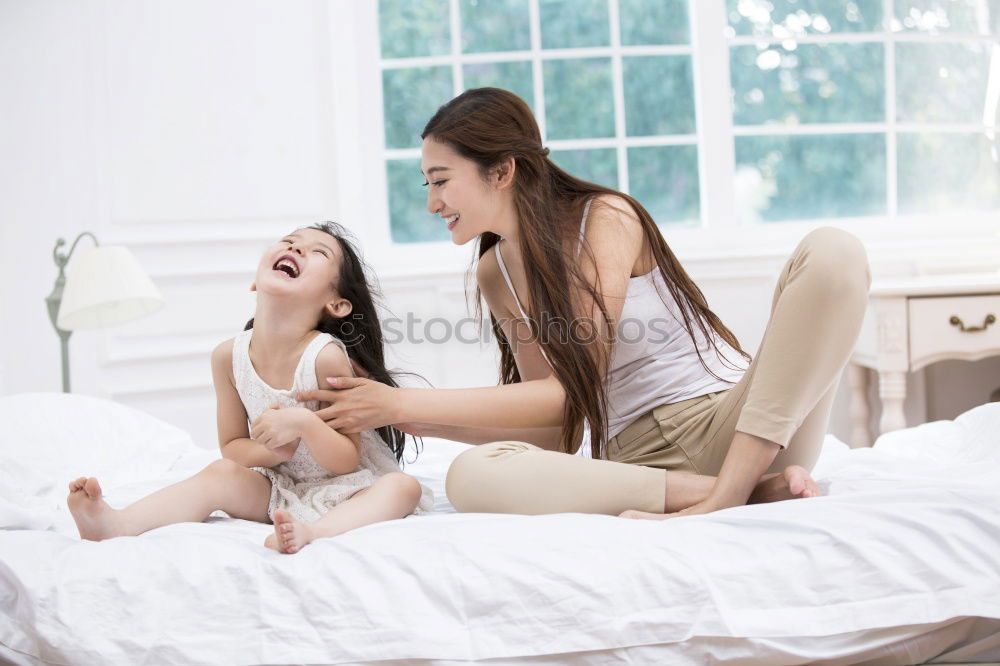 Similar – happy mother and child son fooling and playing in bed