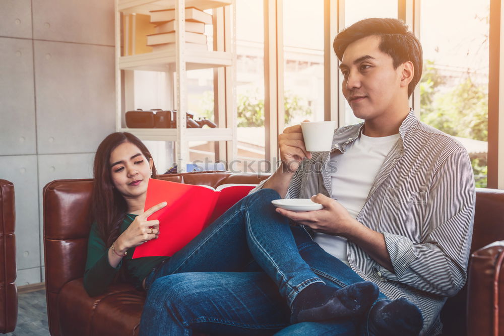 Similar – Image, Stock Photo Young couple reading book on couch at home