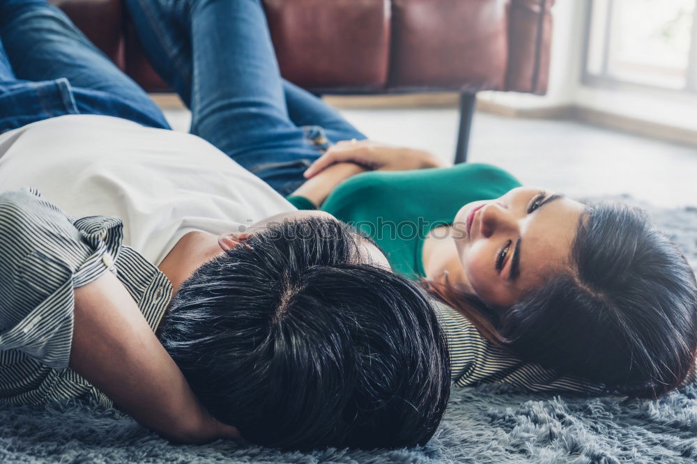 Similar – Couple laying on couch watching TV together