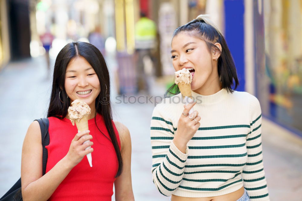 Similar – Girls eating ice cream on the promenade in summer holiday