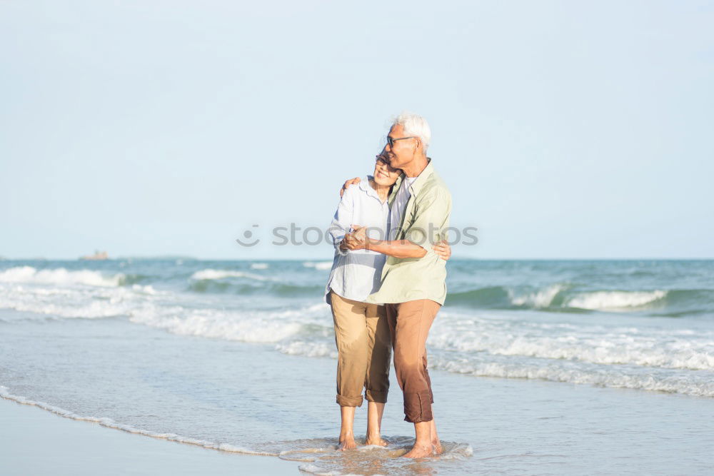 Similar – Father and daughter playing on the beach at the day time.