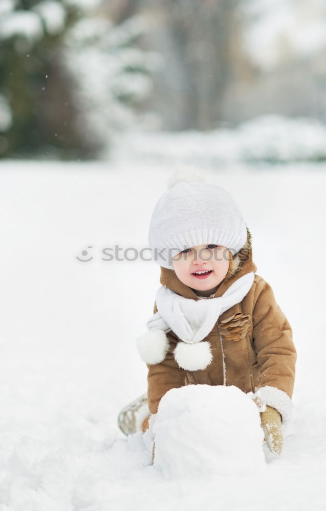 Image, Stock Photo Happy little girl enjoying snow. Child playing outdoors walking through deep snow in wintertime while snow falling. Toddler is wearing dark blue snowsuit