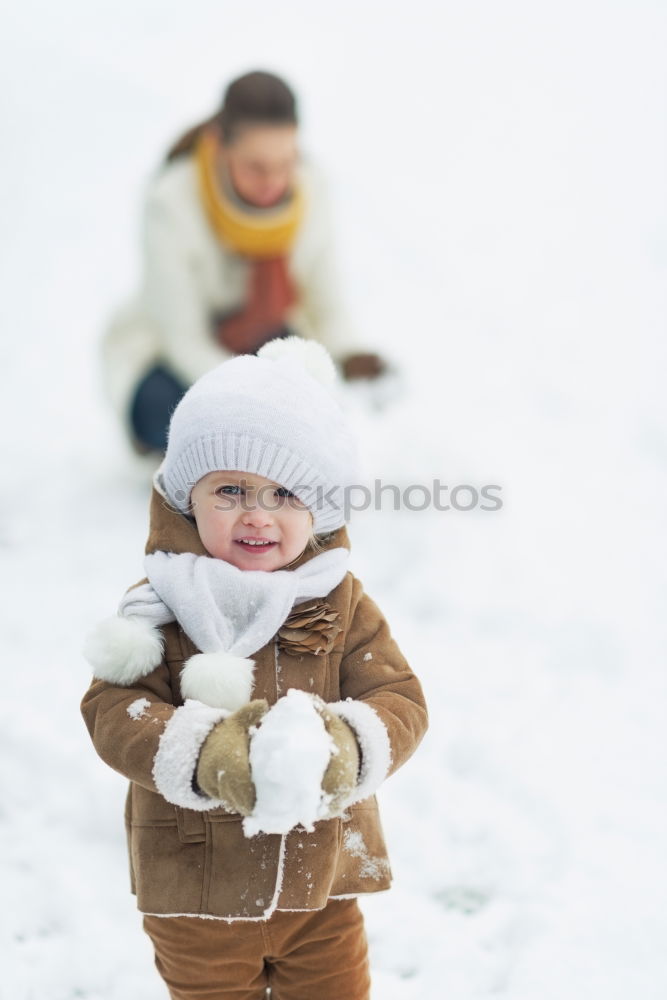 Similar – Mother is playing with her little daughter outdoors in winter