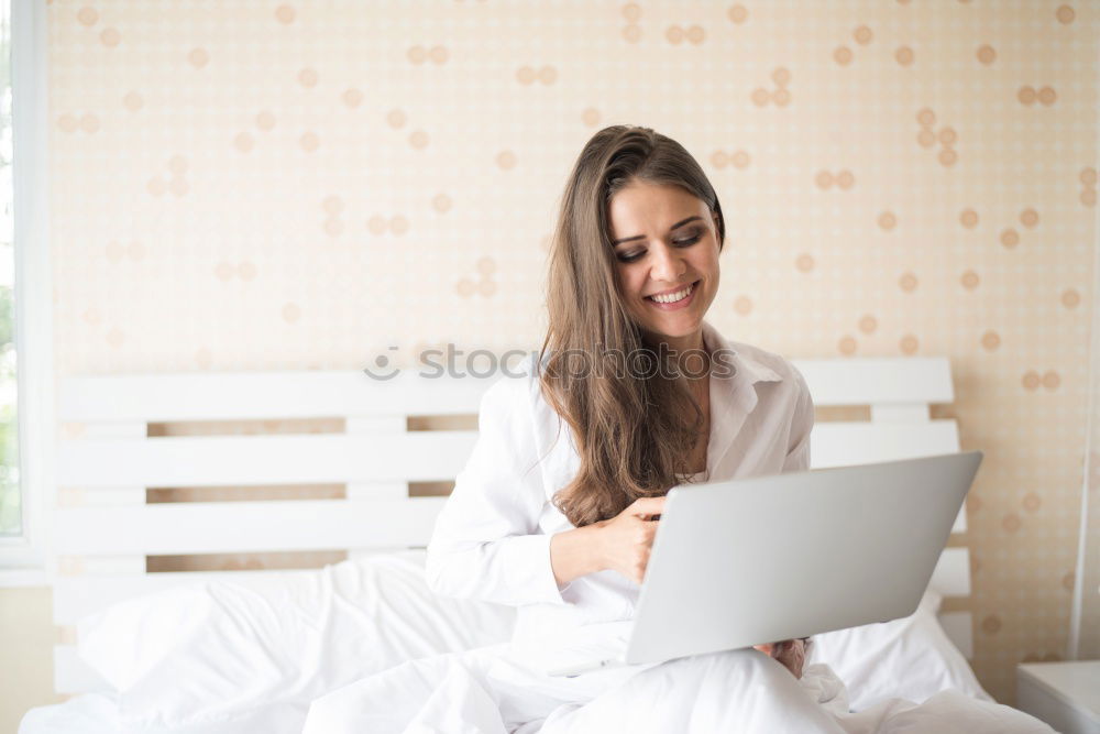 Similar – Beautiful and sexy young woman using Laptop While Sitting On Sofa window on luxury apartment.