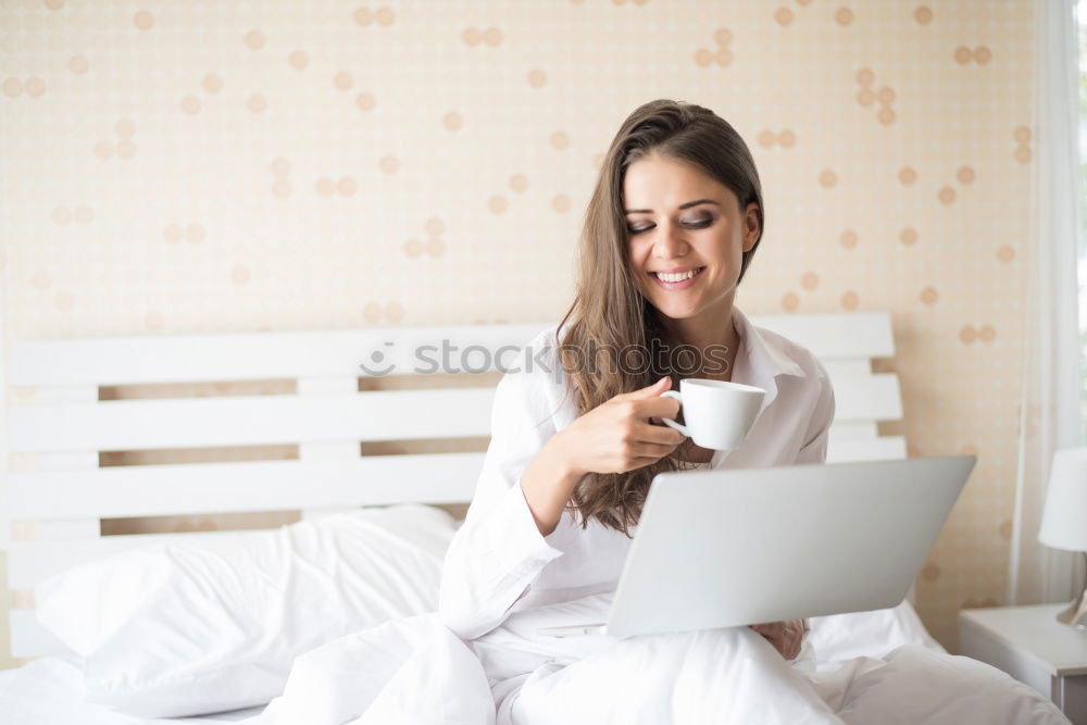 Similar – Beautiful and sexy young woman using Laptop While Sitting On Sofa window on luxury apartment.