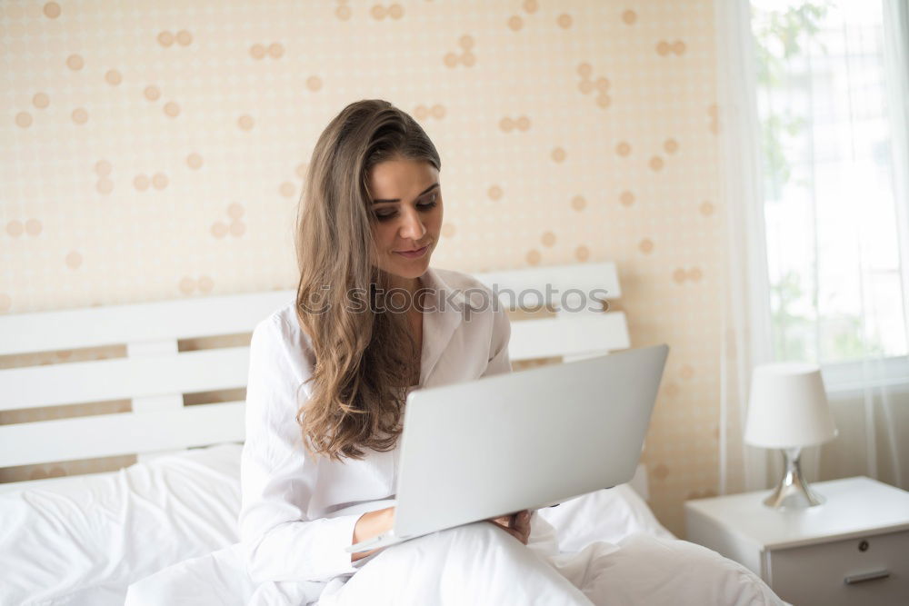 Similar – Beautiful and sexy young woman using Laptop While Sitting On Sofa window on luxury apartment.