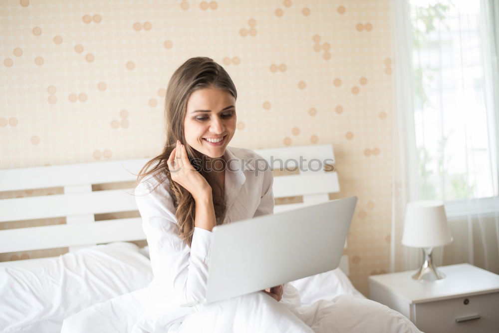 Similar – Beautiful and sexy young woman using Laptop While Sitting On Sofa window on luxury apartment.