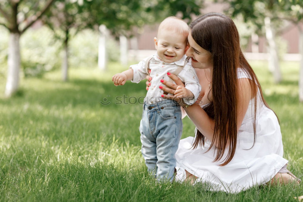 Similar – Image, Stock Photo mother and son playing with soap bubbles in park