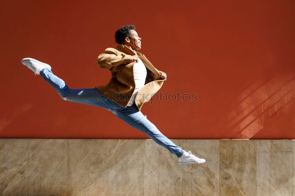 Similar – Image, Stock Photo Young black man wearing casual clothes jumping outdoors
