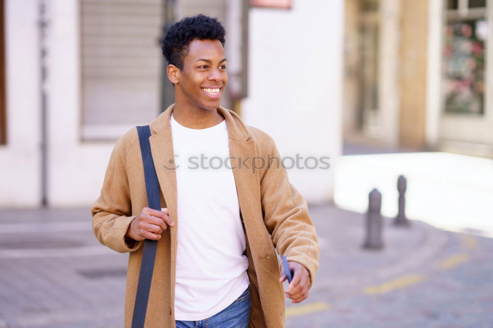 Similar – Young black man walking smiling down the street.