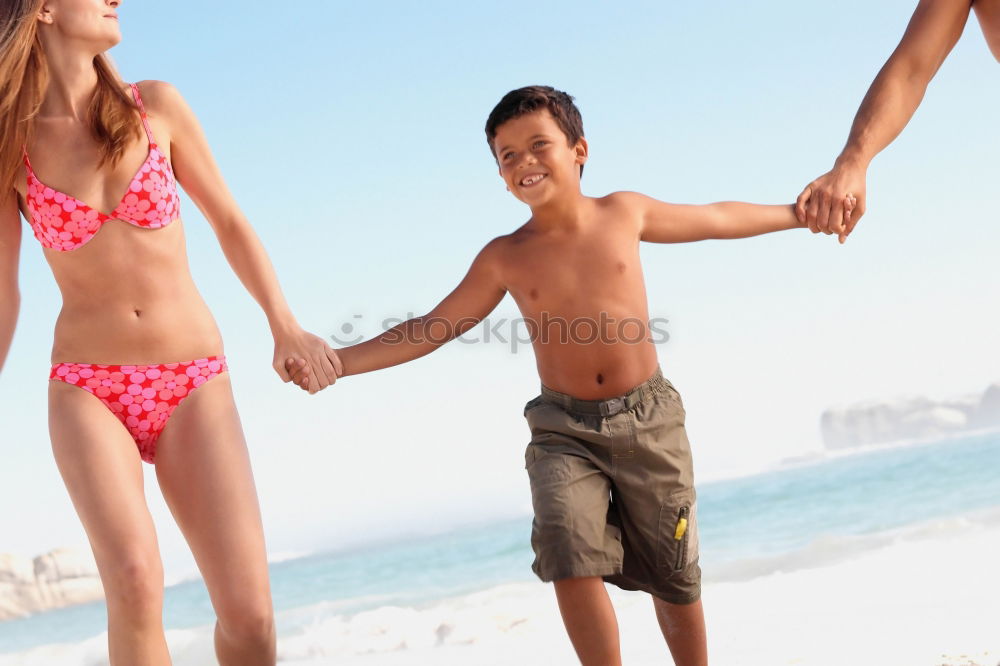 Similar – Image, Stock Photo caucasian mother and son playing with windmill at the beach