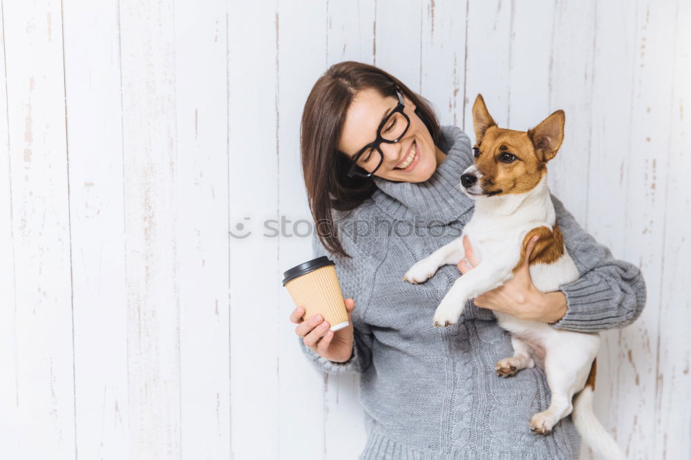 Image, Stock Photo Young woman feeding Beagle at a table in the kitchen in front of turquoise wall at the table