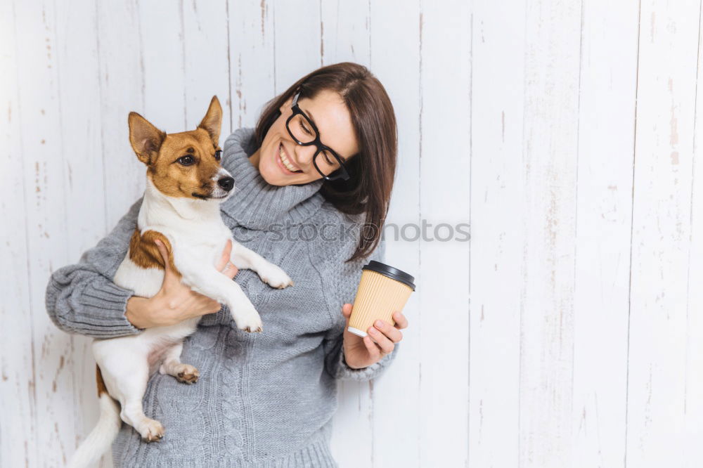 Similar – Image, Stock Photo Young woman feeding Beagle at a table in the kitchen in front of turquoise wall at the table