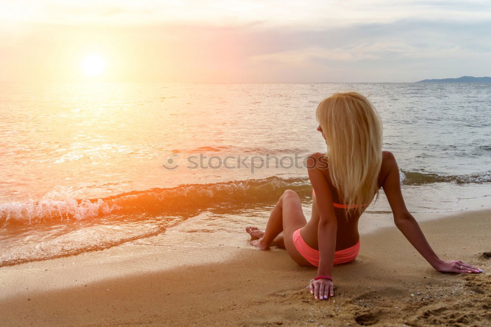 Similar – Image, Stock Photo Beautiful young woman posing on the sand at the beach