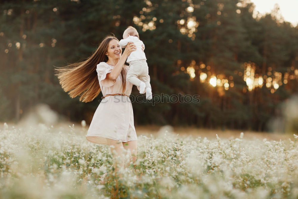 Similar – happy family: young mother walks with her child in the Park