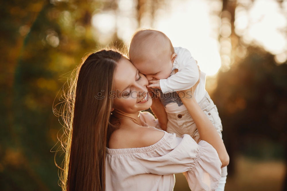 Similar – Foto Bild Mutter hält ihren kleinen Sohn in die Luft und das Baby lacht.