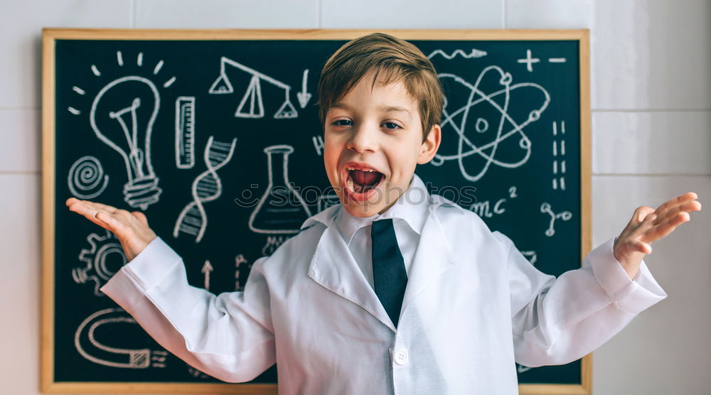 Child dressed as a scientist and chalkboard