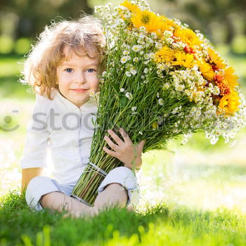 Similar – romantic portrait of happy child girl picking bouquet of beautiful blue delphinium flowers from summer garden