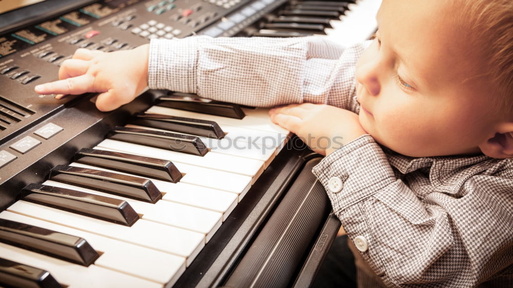 Similar – Toddler plays piano with delicate hands