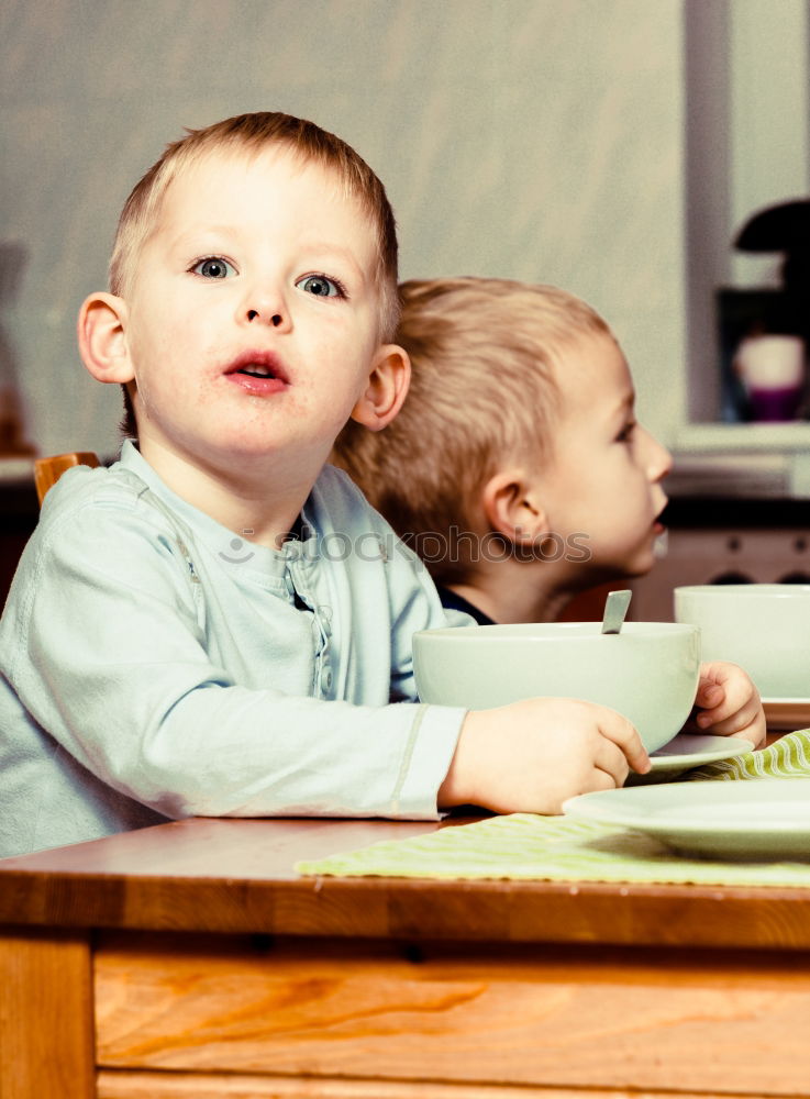 Similar – Woman feeding her little girl in kitchen