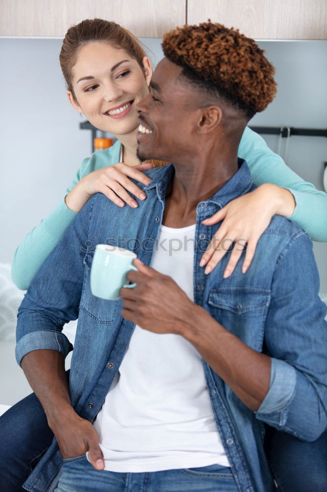 Similar – Loving Young Couple Hugging And Kissing At Home Standing In Kitchen Together