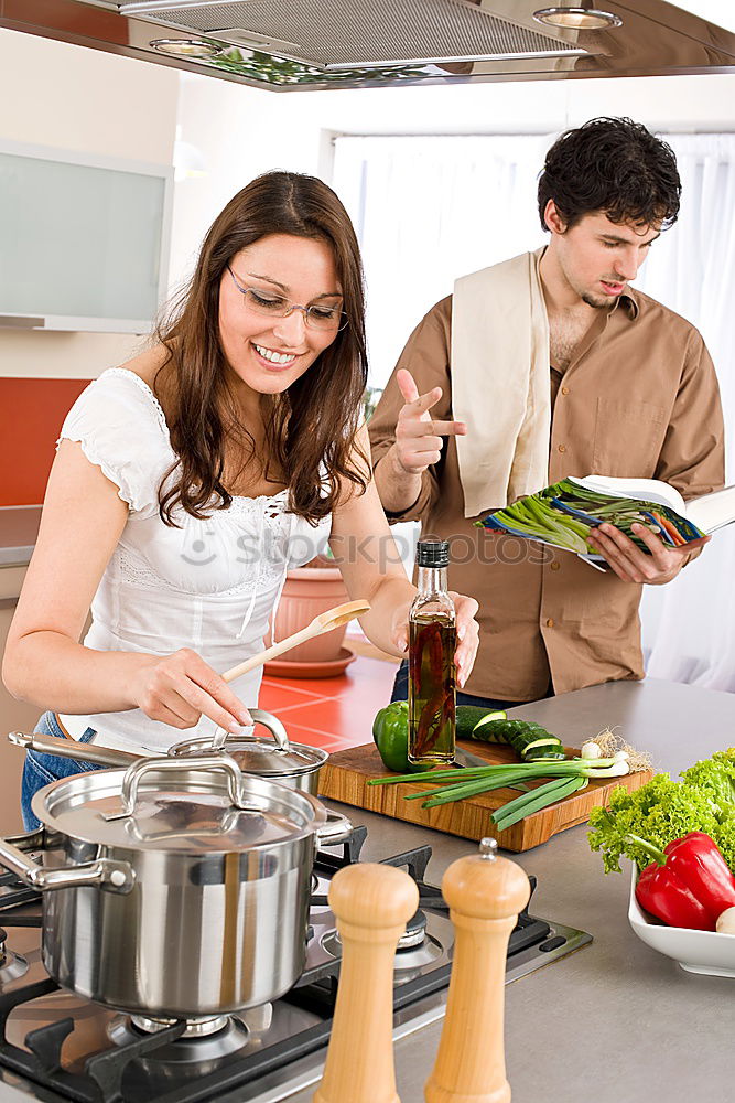 Similar – Image, Stock Photo Young couple cooking. Man and woman in their kitchen