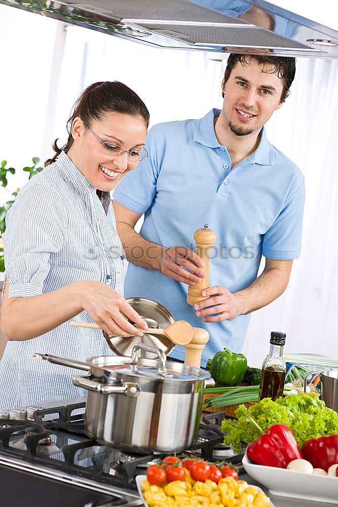 Similar – Image, Stock Photo Young couple cooking. Man and woman in their kitchen