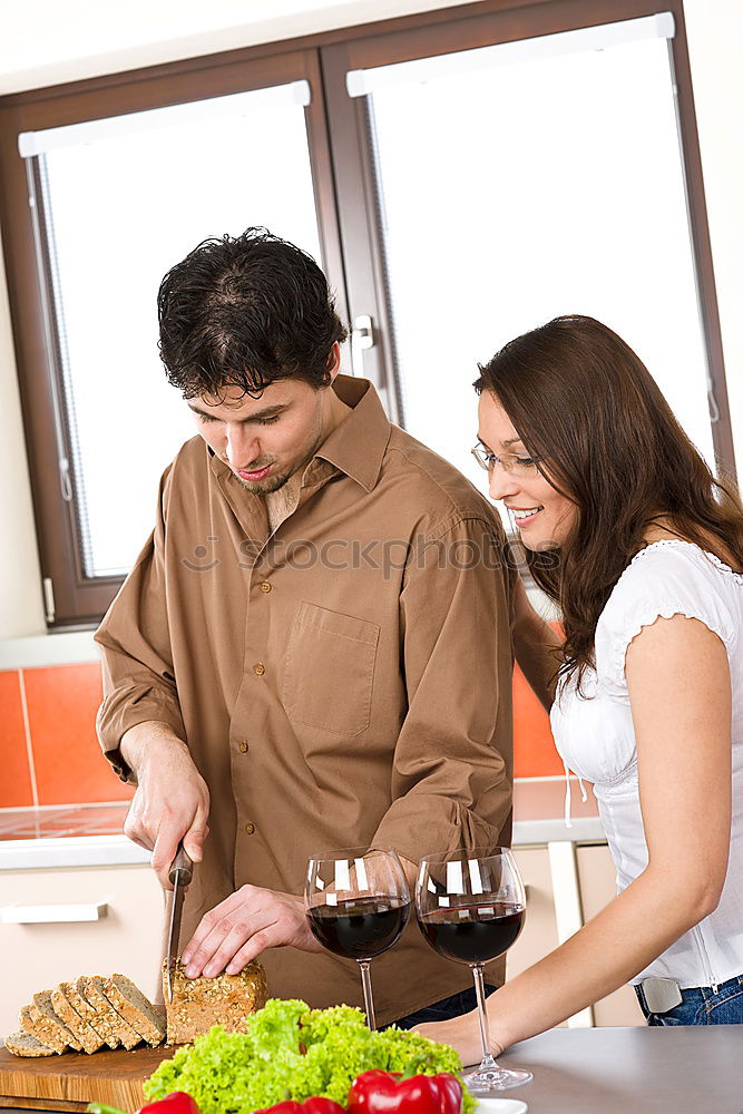 Similar – Image, Stock Photo Young couple cooking. Man and woman in their kitchen