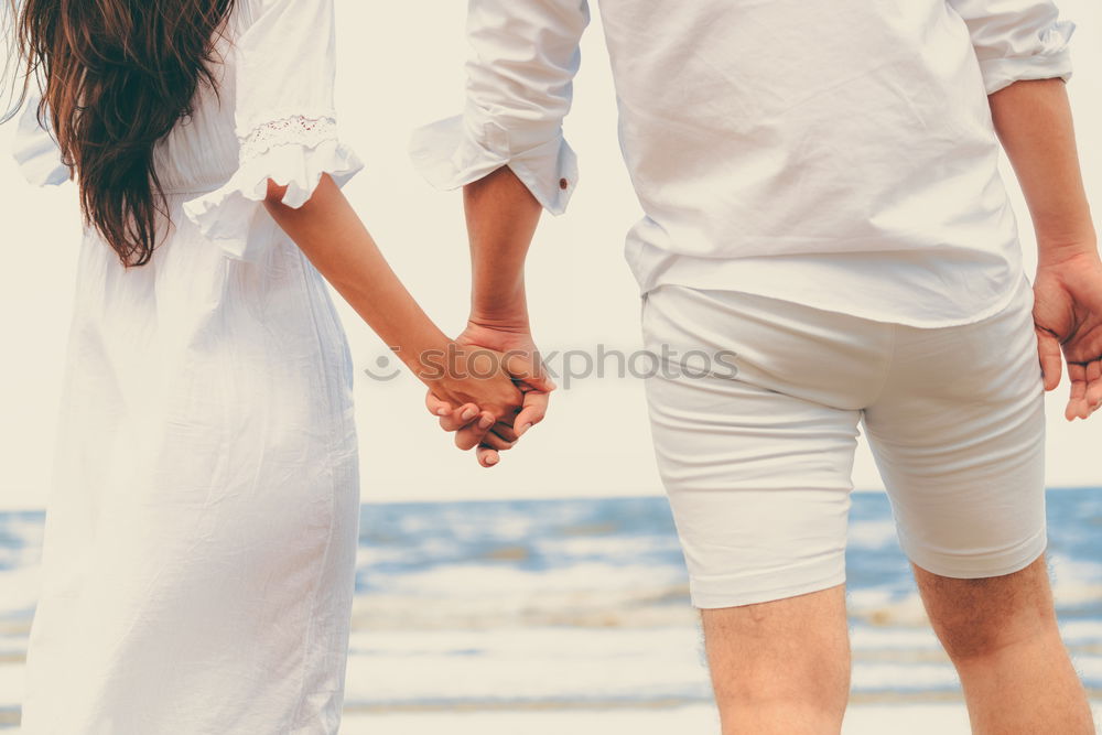 Closeup of couple holding hands