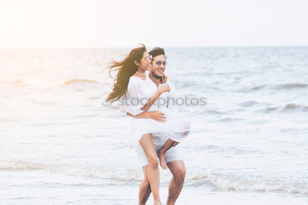 Similar – Image, Stock Photo Young adult couple kissing on beach after running workout