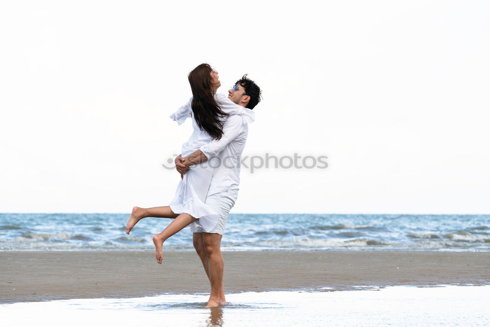 Similar – Father and daughter playing on the beach at the day time.