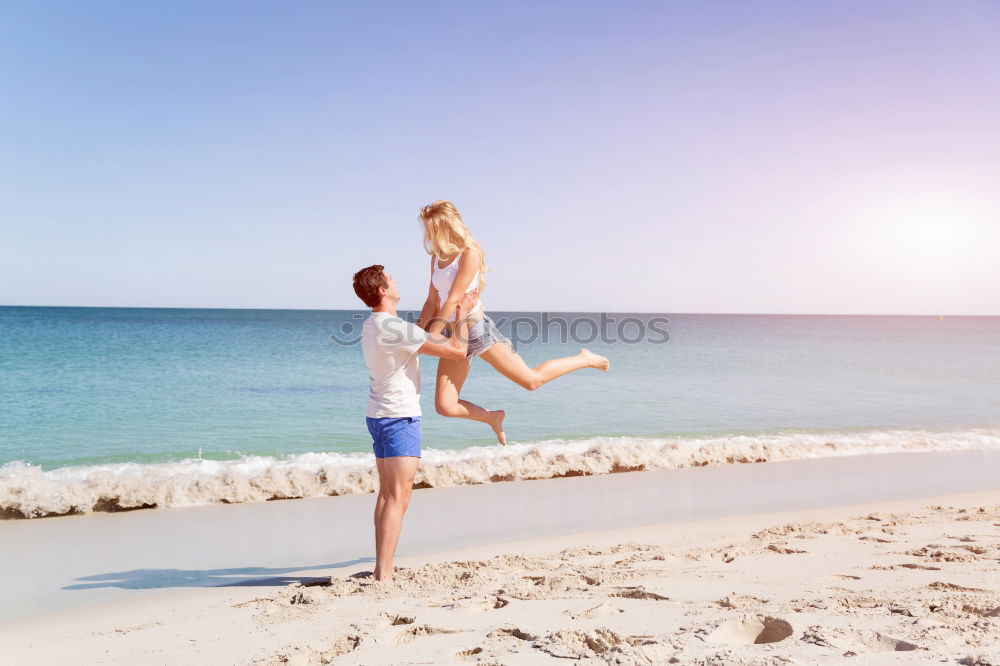 Similar – Father and daughter playing on the beach at the day time.