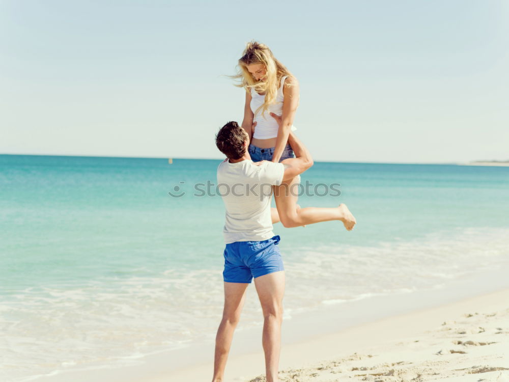 Similar – Father and daughter playing on the beach at the day time.