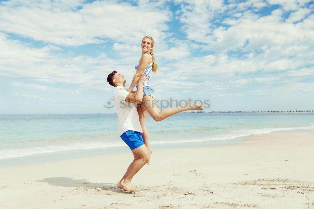 Similar – Father and daughter playing on the beach at the day time.