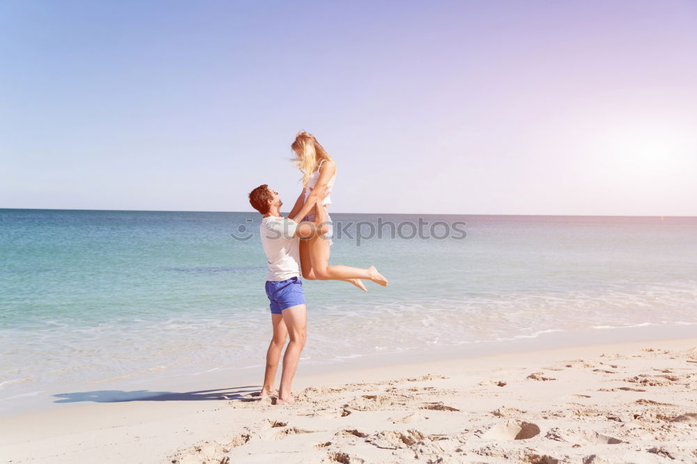 Similar – Father and daughter playing on the beach at the day time.