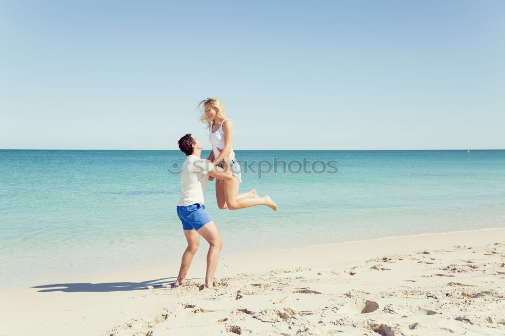 Similar – Father and daughter playing on the beach at the day time.