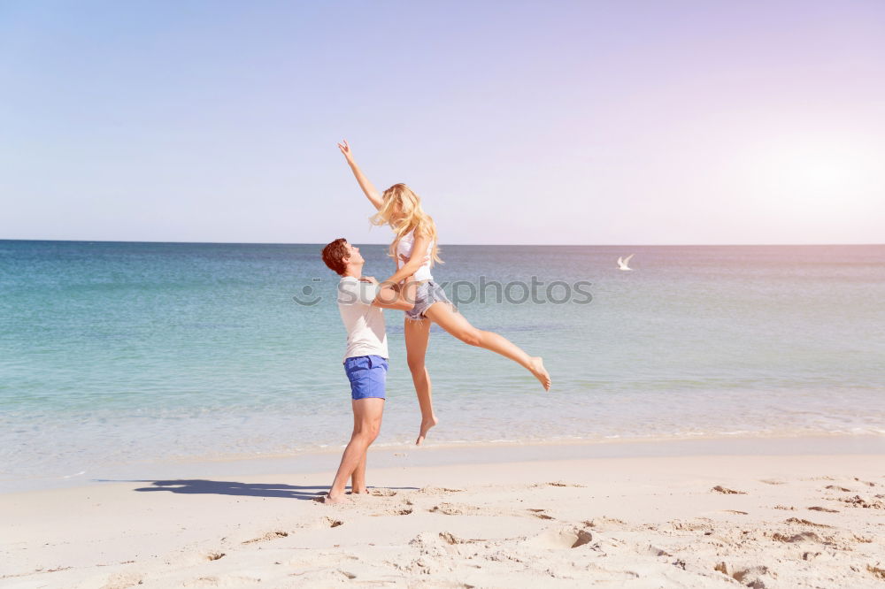 Similar – Father and daughter playing on the beach at the day time.