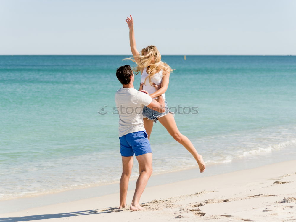 Similar – Father and daughter playing on the beach at the day time.