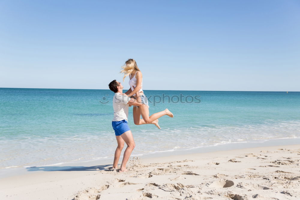 Similar – Father and daughter playing on the beach at the day time.