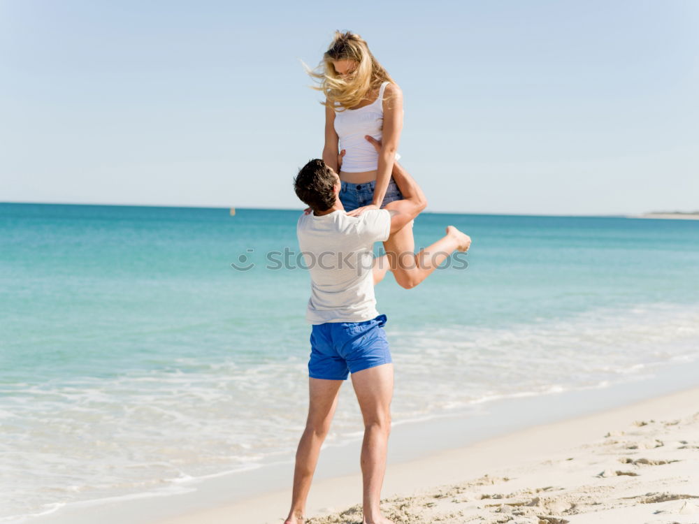 Similar – Father and daughter playing on the beach at the day time.