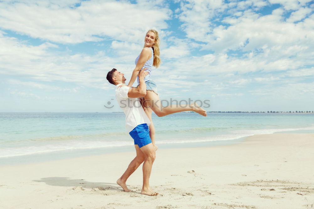 Similar – Father and daughter playing on the beach at the day time.