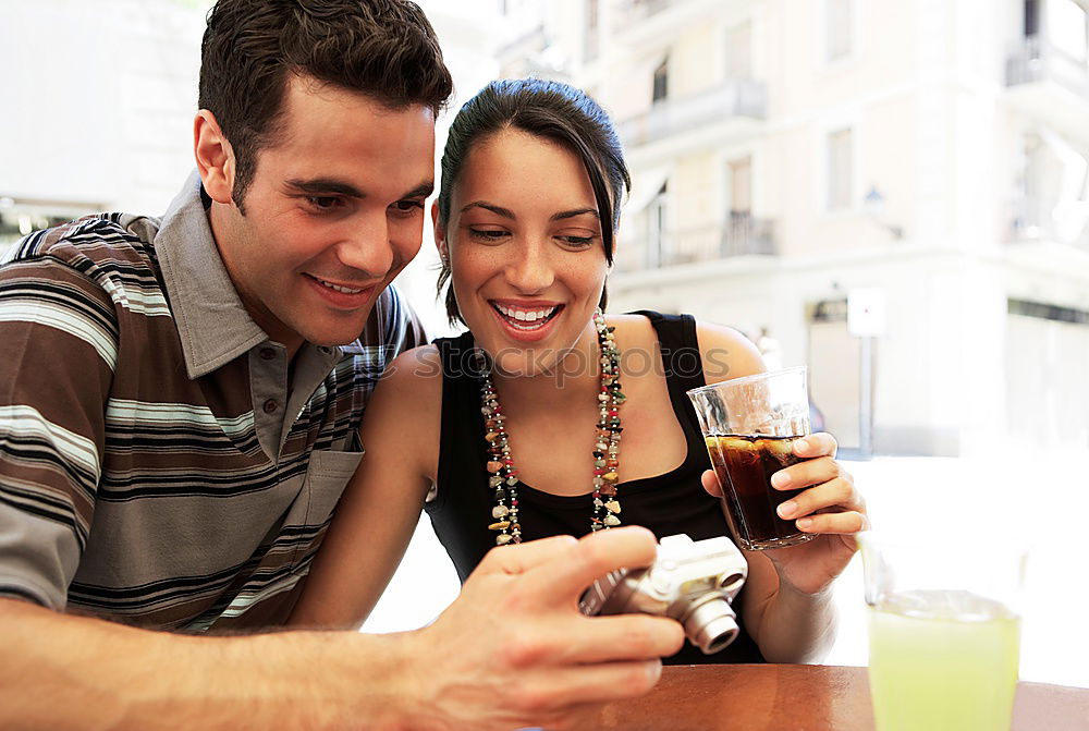 Similar – Image, Stock Photo Happy young couple seating in a restaurant with a smartphone taking a selfie