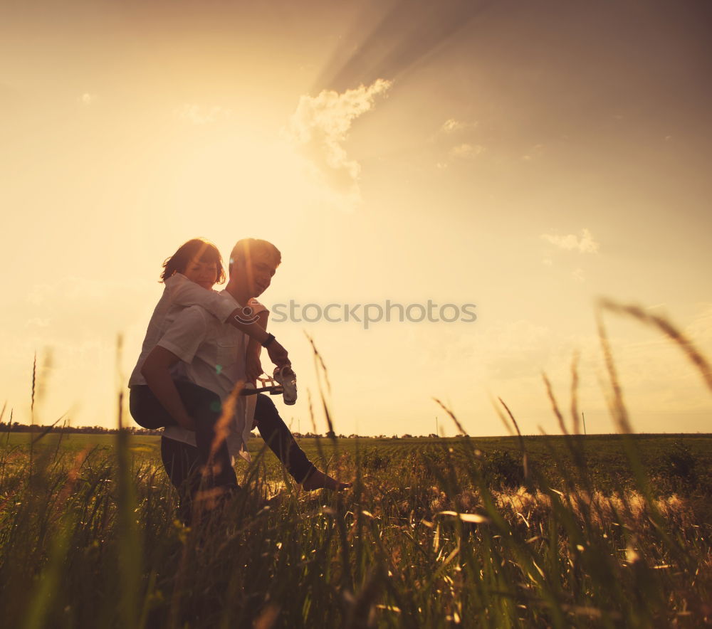 Similar – Mom keeps daughter’s hand and walks on the nature in sunset light