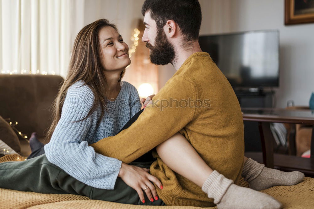 Similar – Couple laying on couch watching TV together