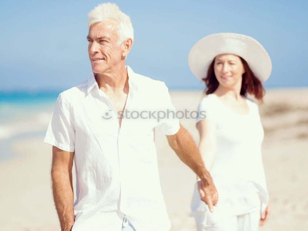 Similar – Senior man and woman having a run along the shore. Scene with sea, sand and trees. Healthy and active way of life