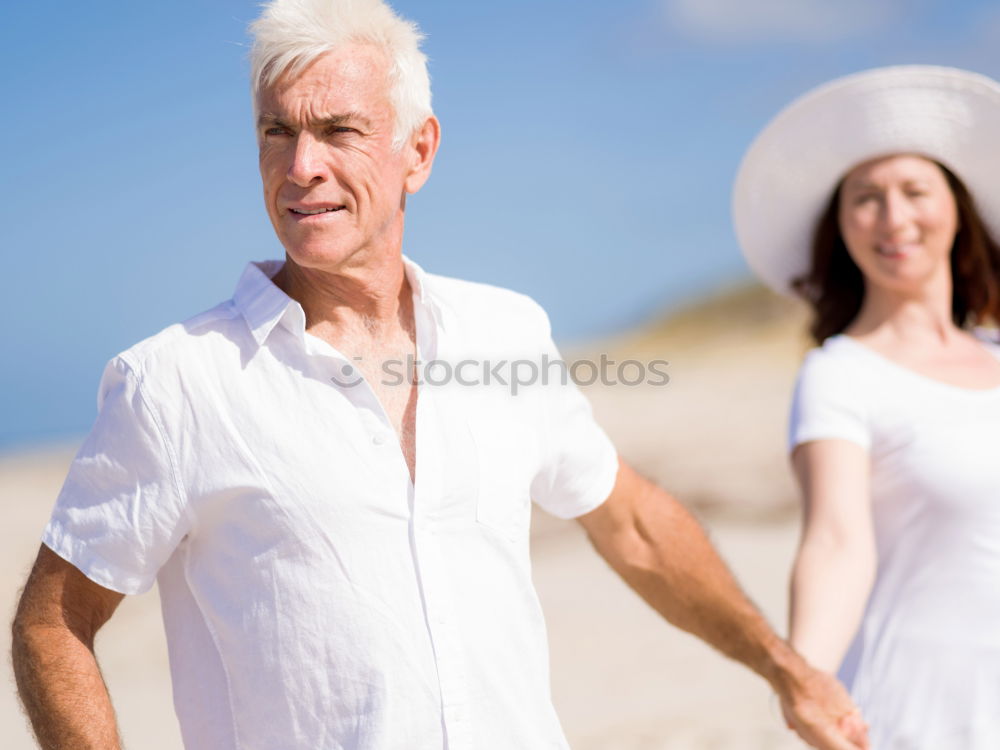 Similar – Senior man and woman having a run along the shore. Scene with sea, sand and trees. Healthy and active way of life